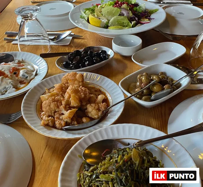 Agora Pansiyon Bafa Gölü’nde zeytinyağlılar, ot yemekleri, salata ve zeytinlerle donatılmış yöresel sofradan bir görünüm